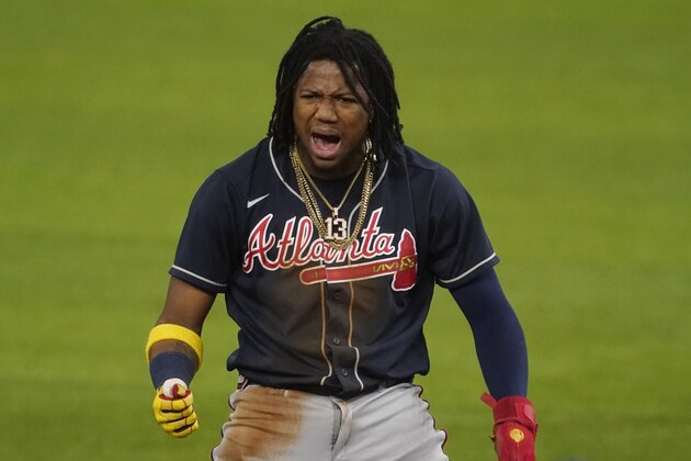 Atlanta Braves' Ronald Acuna Jr. celebrates after a double against the Los Angeles Dodgers during the first inning in Game 7 of a baseball National League Championship Series Sunday, Oct. 18, 2020, in Arlington, Texas. (AP Photo/Tony Gutierrez)