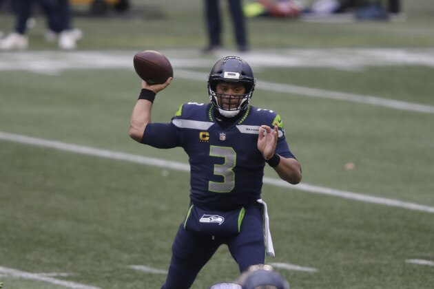 Seattle Seahawks quarterback Russell Wilson in action against the Los Angeles Rams during the first half of an NFL wild-card playoff football game, Saturday, Jan. 9, 2021, in Seattle. (AP Photo/Scott Eklund)