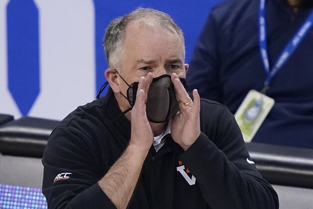Virginia Tech head coach Mike Young directs his team during the first half of an NCAA college basketball game against North Carolina in the quarterfinal round of the Atlantic Coast Conference tournament in Greensboro, N.C., Thursday, March 11, 2021. (AP Photo/Gerry Broome)
