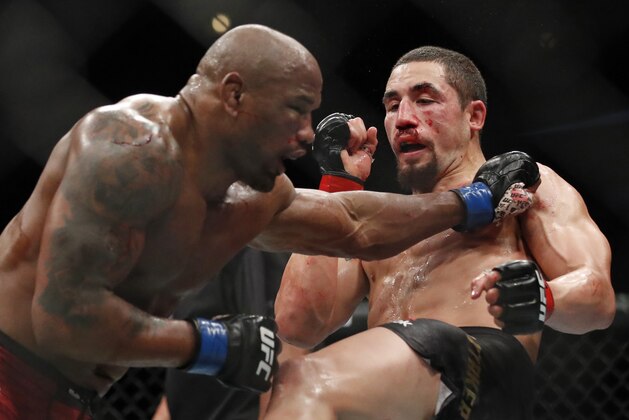 Robert Whittaker, right, and Yoel Romero fight during their middleweight title bout at the UFC 225 mixed martial arts event early Sunday, June 10, 2018, in Chicago. (AP Photo/Jim Young)