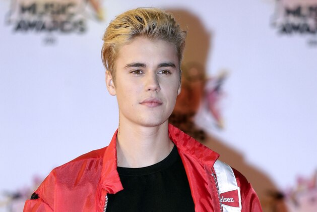 FILE - In this Nov. 7, 2015 file photo, Justin Bieber arrives at the Cannes festival palace in Cannes, southeastern France. Beverly Hills police said Thursday, Aug. 3, 2017, that Bieber will not face any criminal penalties after he accidentally struck a paparazzo with his pickup truck after leaving an event on July 26.  They also say Bieber will not face any traffic citations. (AP Photo/Lionel Cironneau, File)