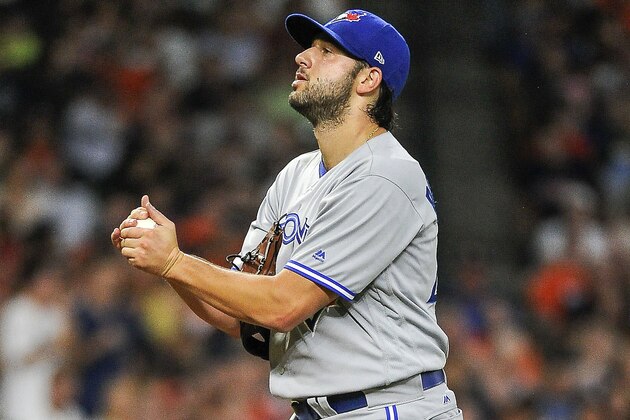 Toronto Blue Jays relief pitcher Mike Bolsinger walks up the mound after walking Houston Astros' Derek Fisher to load the bases during the fourth inning of a baseball game, Friday, Aug. 4, 2017, in Houston. (AP Photo/Eric Christian Smith)
