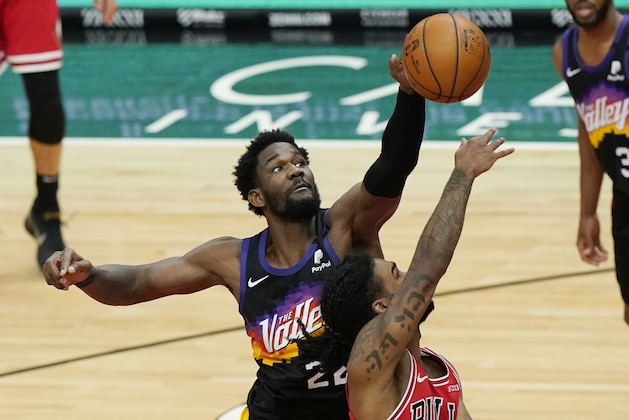 Phoenix Suns center Deandre Ayton, left, blocks a shot by Chicago Bulls guard Coby White during the second half of an NBA basketball game in Chicago, Friday, Feb. 26, 2021. (AP Photo/Nam Y. Huh)