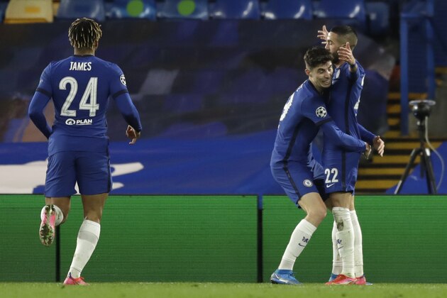 Chelsea's Hakim Ziyech, right, celebrates after scoring his side's opening goal during the Champions League, round of 16, second leg soccer match between Chelsea and Atletico Madrid at the Stamford Bridge stadium, London, Wednesday, March 17, 2021. (AP Photo/Matt Dunham)