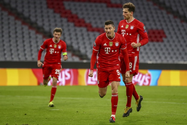 Bayern's Robert Lewandowski celebrates after scoring from a penalty kick during the Champions League, round of 16, second leg soccer match between FC Bayern Munich and Lazio at the soccer Arena stadium in Munich, Germany, Wednesday, March 17, 2021. (AP Photo/Matthias Schrader)