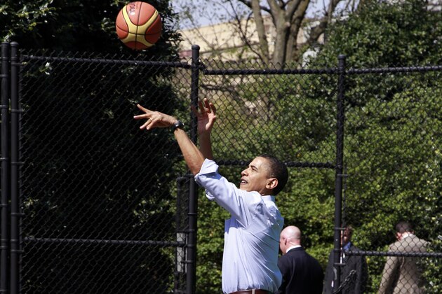 President Barack Obama shoots a basketball during the annual Easter Egg Roll at the White House in Washington, Monday, April 5, 2010. (AP Photo/Alex Brandon)
