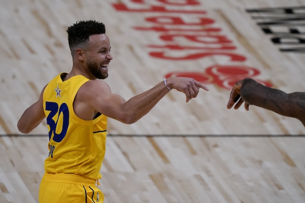 Golden State Warriors guard Stephen Curry celebrates during the first half of basketball's NBA All-Star Game in Atlanta, Sunday, March 7, 2021. (AP Photo/Brynn Anderson)