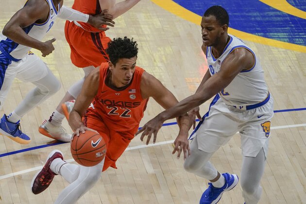 Virginia Tech's Keve Aluma (22) drives towards Pittsburgh's Abdoul Karim Coulibaly (12) during the first half of an NCAA college basketball game, Wednesday, Feb. 3, 2021, in Pittsburgh. (AP Photo/Keith Srakocic)