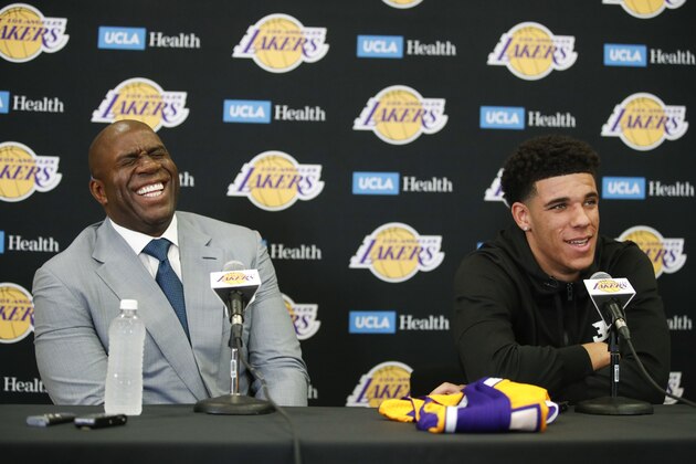 Magic Johnson, left, laughs as Los Angeles Lakers draft pick Lonzo Ball tells reporters he hadn't been born when Johnson played for the Lakers. during a news conference, Friday, June 23, 2017, in El Segundo, Calif. (AP Photo/Jae C. Hong)