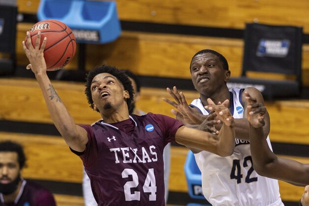 Texas Southern forward John Walker III (24) grabs a rebound next to Mount St. Mary's forward Malik Jefferson (42) during the second half of a First Four game in the NCAA men's college basketball tournament Thursday, March 18, 2021, in Bloomington, Ind. (AP Photo/Doug McSchooler)
