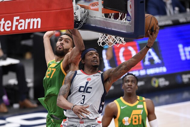 Washington Wizards guard Bradley Beal (3) goes to the basket past Utah Jazz center Rudy Gobert (27) during the second half of an NBA basketball game, Thursday, March 18, 2021, in Washington. (AP Photo/Nick Wass)