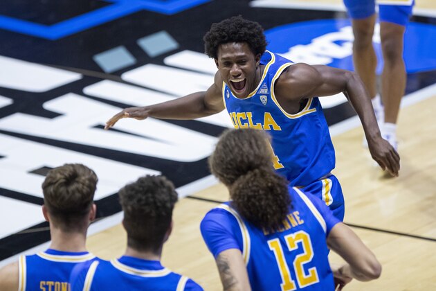 UCLA's David Singleton, top, runs to celebrate with teammates following their 86-80 win over Michigan State in a First Four game in the NCAA men's college basketball tournament, early Friday, March 19, 2021, at Mackey Arena in West Lafayette, Ind. (AP Photo/Robert Franklin)
