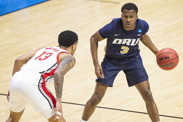 Oral Roberts' Max Abmas (3) drives against Ohio State's CJ Walker (13) during the first half of a first round game in the NCAA men's college basketball tournament, Friday, March 19, 2021, at Mackey Arena in West Lafayette, Ind. (AP Photo/Robert Franklin)