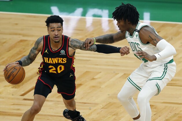 Boston Celtics' Robert Williams III (44) defends against Atlanta Hawks' John Collins (20) during the first half of an NBA basketball game Friday, Feb. 19, 2021, in Boston. (AP Photo/Michael Dwyer)