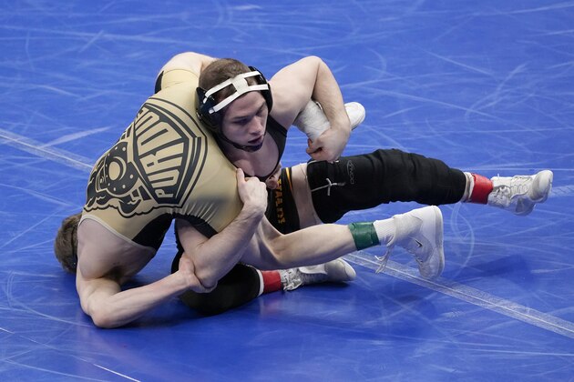 Iowa's Spencer Lee, right, takes on Purdue's Devin Schroder during their 125-pound match in the quarterfinal round of the NCAA wrestling championships Friday, March 19, 2021, in St. Louis. (AP Photo/Jeff Roberson) Iowa's Spencer Lee, right, takes on Purdue's Devin Schroder during their 125-pound match in the quarterfinal round of the NCAA wrestling championships Friday, March 19, 2021, in St. Louis. (AP Photo/Jeff Roberson)
