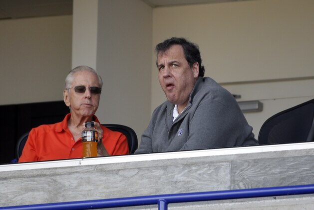 New Jersey Gov. Chris Christie, right, sits next to New York Mets owner Fred Wilpon before the start of an exhibition spring training baseball game between the New York Mets and the New York Yankees Wednesday, March 9, 2016, in Port St. Lucie, Fla. (AP Photo/Jeff Roberson)
