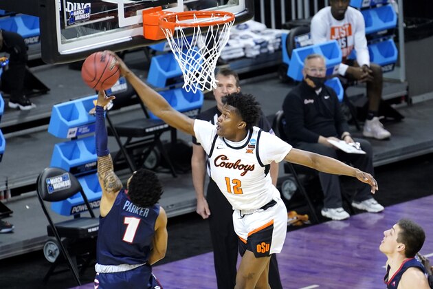 Oklahoma State forward Matthew-Alexander Moncrieffe (12) blocks the shot of Liberty's Chris Parker during the first half of a first round NCAA college basketball game Friday, March 19, 2021, at the Indiana Farmers Coliseum in Indianapolis. (AP Photo/Charles Rex Arbogast)
