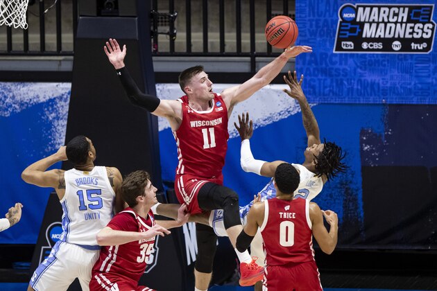 Wisconsin's Micah Potter (11) blocks a shot by North Carolina's Caleb Love (2) during the first half of a first-round game in the NCAA men's college basketball tournament Friday, March 19, 2021, at Mackey Arena in West Lafayette, Ind. (AP Photo/Robert Franklin) Wisconsin's Micah Potter (11) blocks a shot by North Carolina's Caleb Love (2) during the first half of a first-round game in the NCAA men's college basketball tournament Friday, March 19, 2021, at Mackey Arena in West Lafayette, Ind. (AP Photo/Robert Franklin)