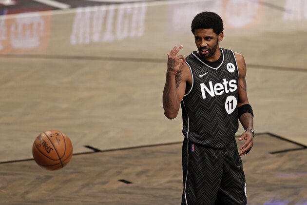 Brooklyn Nets guard Kyrie Irving (11) reacts against the Boston Celtics during the first half of an NBA basketball game, Thursday, March 11, 2021, in New York. (AP Photo/Adam Hunger)