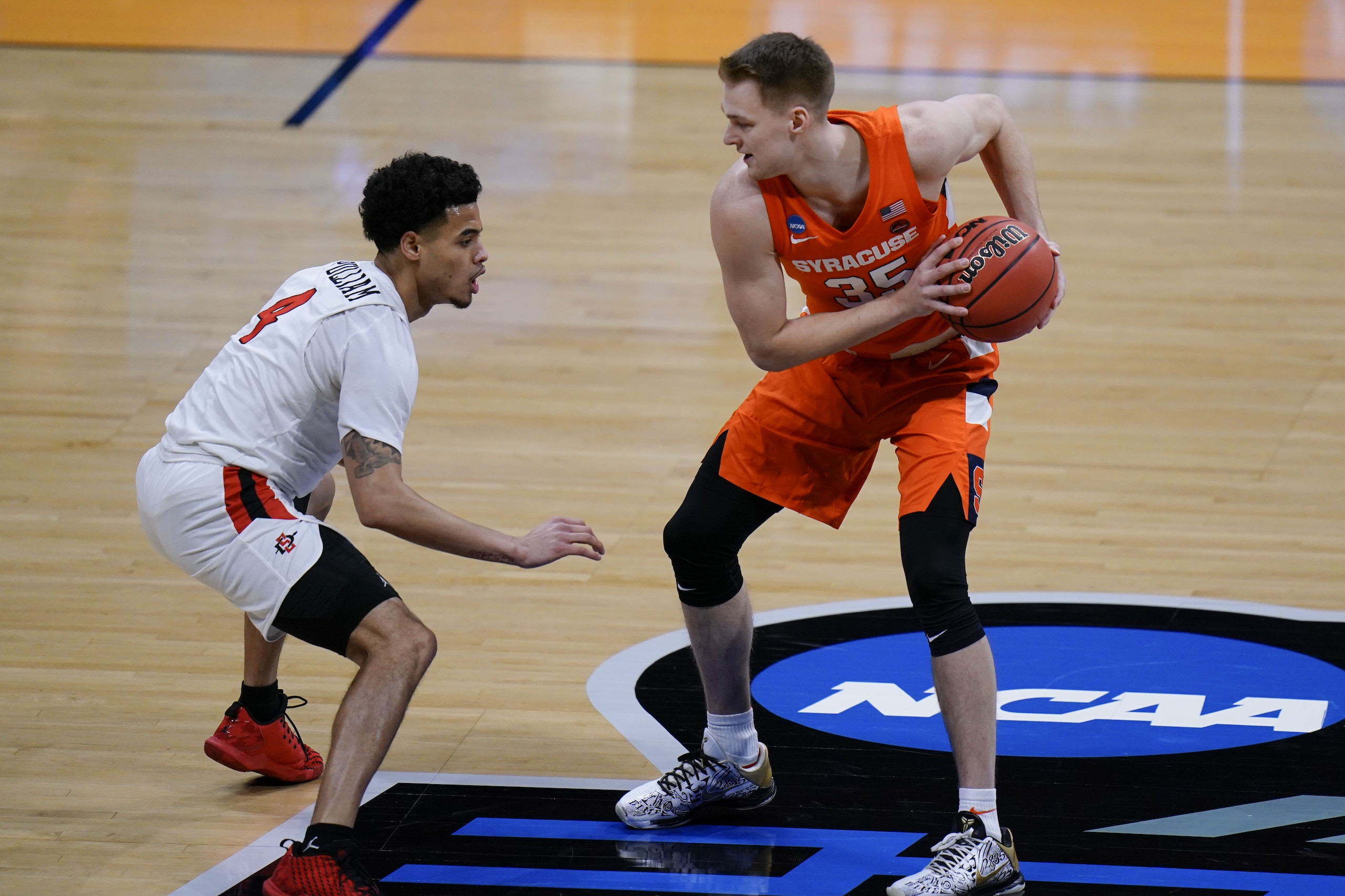 Syracuse guard Buddy Boeheim (35) is defended by San Diego State guard Trey Pulliam (4) during the first half of a college basketball game in the first round of the NCAA tournament at Hinkle Fieldhouse in Indianapolis, Friday, March 19, 2021. (AP Photo/AJ Mast)