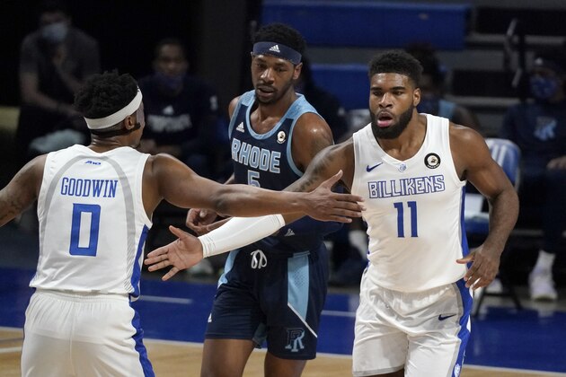 Saint Louis' Hasahn French (11) is congratulated by teammate Jordan Goodwin (0) after making a layup as Rhode Island's Antwan Walker watches during the first half of an NCAA college basketball game Wednesday, Feb. 10, 2021, in St. Louis. (AP Photo/Jeff Roberson)