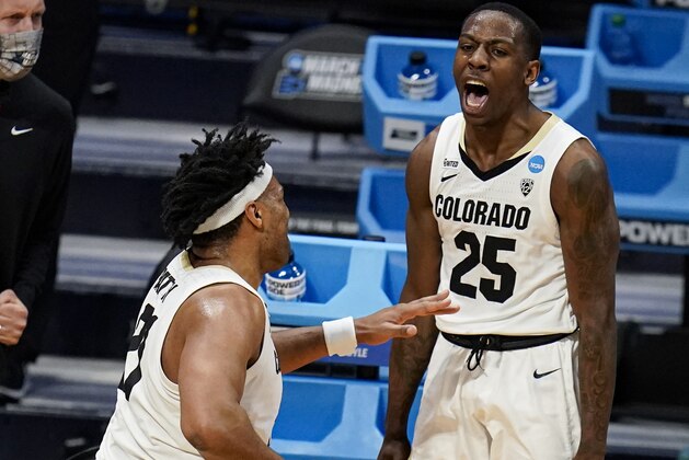 Colorado guard McKinley Wright IV (25) celebrates with forward Evan Battey (21) in the first half of a first-round game against Georgetown in the NCAA men's college basketball tournament at Hinkle Fieldhouse in Indianapolis, Saturday, March 20, 2021. (AP Photo/Michael Conroy) Colorado guard McKinley Wright IV (25) celebrates with forward Evan Battey (21) in the first half of a first-round game against Georgetown in the NCAA men's college basketball tournament at Hinkle Fieldhouse in Indianapolis, Saturday, March 20, 2021. (AP Photo/Michael Conroy)