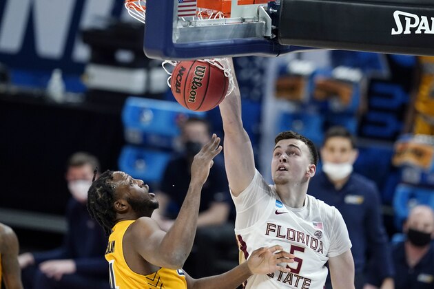 Florida State's Balsa Koprivica (5) dunks against UNC-Greensboro's Mohammed Abdulsalam (4) during the first half of a first-round game in the NCAA men's college basketball tournament at Banker's Life Fieldhouse, Saturday, March 20, 2021, in Indianapolis. (AP Photo/Darron Cummings)