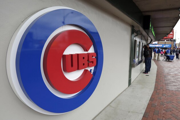 FILE - This April 15, 2013, file photo shows the Chicago Cubs logo on the exterior of Wrigley Field, in Chicago. The Chicago Cubs and Sinclair Broadcast Group are launching a regional sports network in 2020 that will be the team’s exclusive TV home. The Cubs said Wednesday, Feb. 13, 2019, the Marquee Sports Network will carry live game broadcasts and pregame and postgame coverage. (AP Photo/M. Spencer Green, File)
