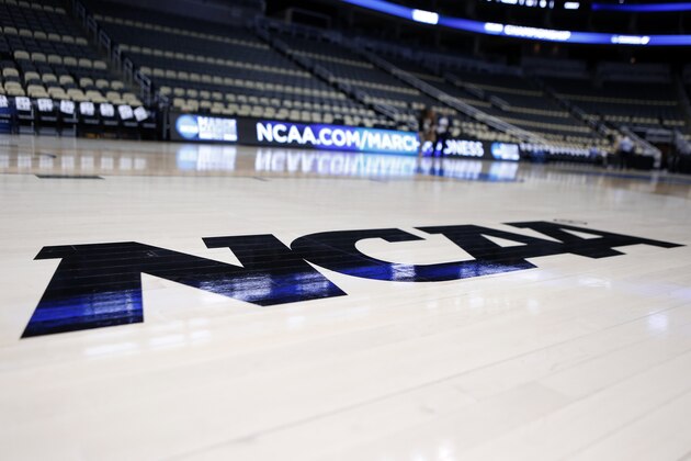 FILE - In this March 18, 2015, file photo, the NCAA logo is displayed on the court as work continues at The Consol Energy Center in Pittsburgh. Coaches did the best they could to prepare for the big moment, yet still find themselves in a scramble once it actually happened. The NCAA announced last month that the season would begin on Nov. 25 and teams are still trying to fill all the holes in their schedules. (AP Photo/Keith Srakocic, File) FILE - In this March 18, 2015, file photo, the NCAA logo is displayed on the court as work continues at The Consol Energy Center in Pittsburgh. Coaches did the best they could to prepare for the big moment, yet still find themselves in a scramble once it actually happened. The NCAA announced last month that the season would begin on Nov. 25 and teams are still trying to fill all the holes in their schedules. (AP Photo/Keith Srakocic, File)