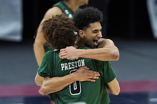Ohio's Ben Roderick, right, hugs Jason Preston after Ohio defeated Buffalo 84-69 in an NCAA college basketball game in the championship of the Mid-American Conference tournament, Saturday, March 13, 2021, in Cleveland. (AP Photo/Tony Dejak)