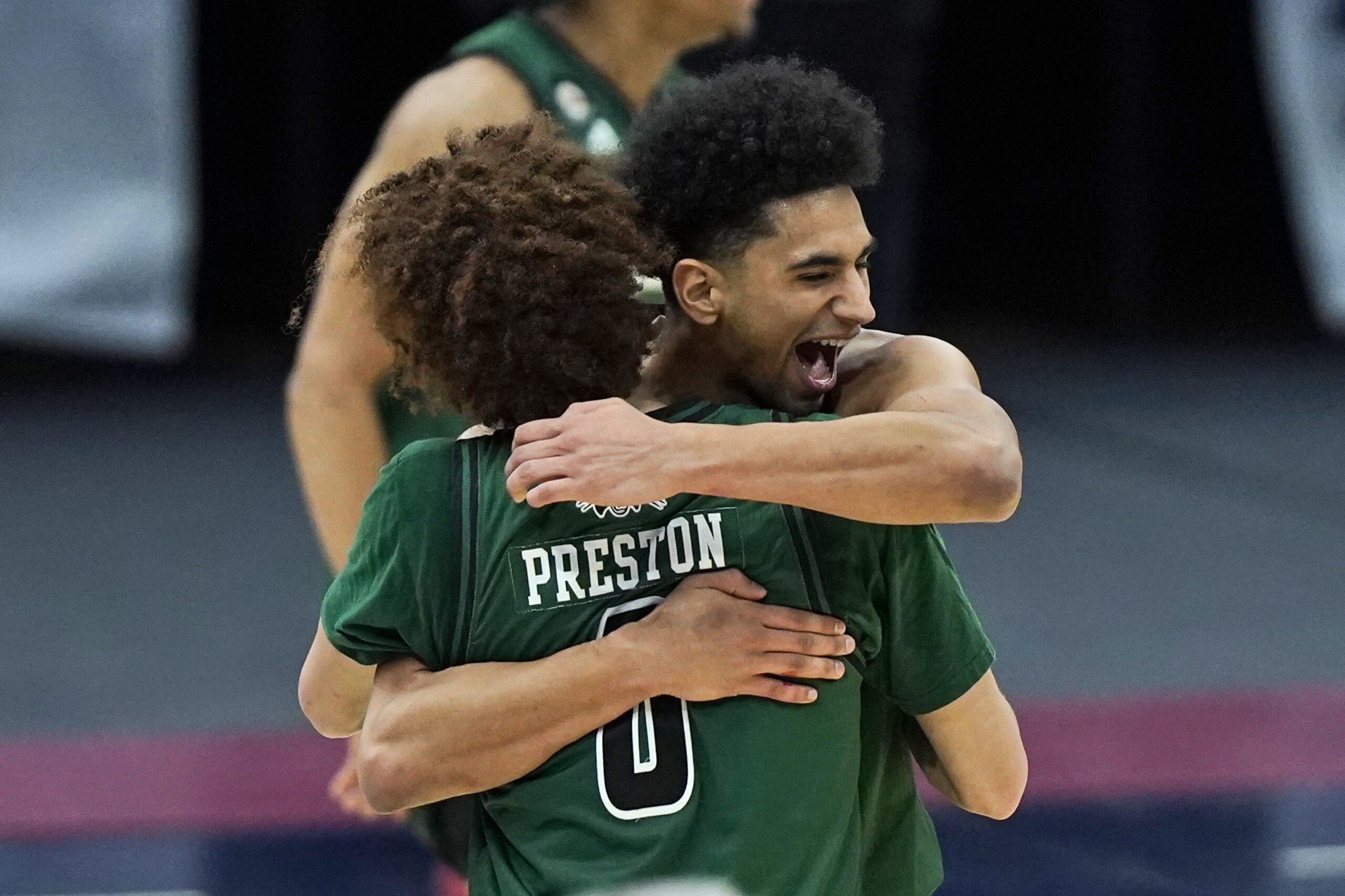Ohio's Ben Roderick, right, hugs Jason Preston after Ohio defeated Buffalo 84-69 in an NCAA college basketball game in the championship of the Mid-American Conference tournament, Saturday, March 13, 2021, in Cleveland. (AP Photo/Tony Dejak)