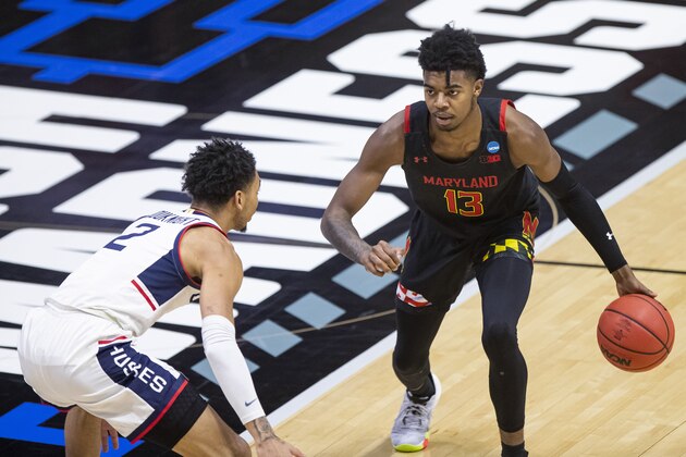 Maryland's Hakim Hart (13) is defended by Connecticut's James Bouknight (2) during the first half of a first-round game in the NCAA men's college basketball tournament Saturday, March 20, 2021, at Mackey Arena in West Lafayette, Ind. (AP Photo/Robert Franklin)