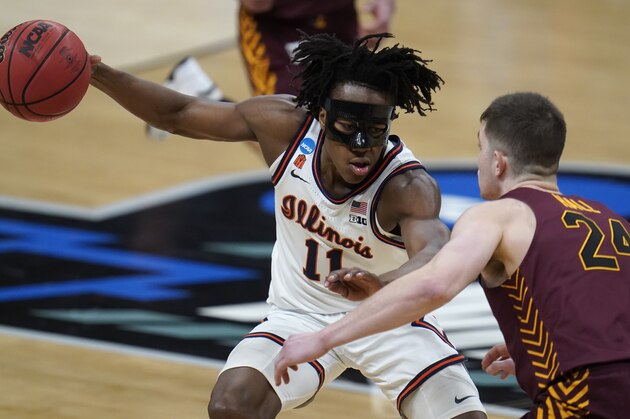 Illinois guard Ayo Dosunmu (11) drives on Loyola Chicago guard Tate Hall (24) during the first half of a men's college basketball game in the second round of the NCAA tournament at Bankers Life Fieldhouse in Indianapolis, Sunday, March 21, 2021. (AP Photo/Paul Sancya)