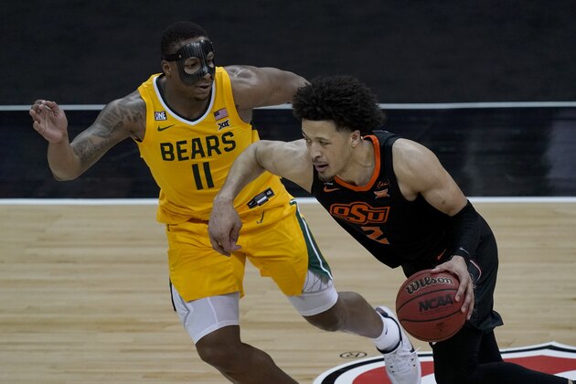 Oklahoma State's Cade Cunningham (2) drives under pressure from Baylor's Mark Vital (11) during the second half of an NCAA college basketball game in the semifinals of the Big 12 tournament in Kansas City, Mo., Friday, March 12, 2021. (AP Photo/Charlie Riedel)