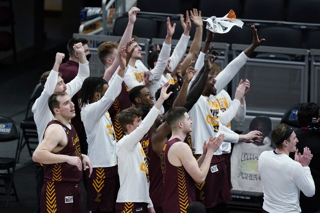 Loyola of Chicago players celebrate after beating Illinois in a college basketball game in the second round of the NCAA tournament at Bankers Life Fieldhouse in Indianapolis Sunday, March 21, 2021. Loyola upset Illinois 71-58. (AP Photo/Mark Humphrey)