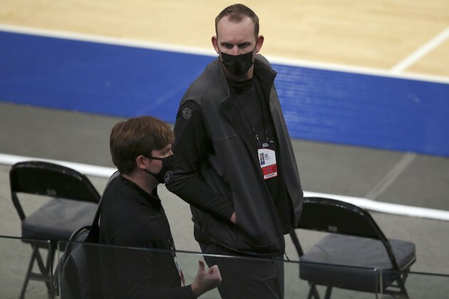 Brooklyn Nets general manager Sean Marks, right, talks to Ryan Gisriel, director of basketball operations, as they walk near the court as players warm up for an NBA basketball game against the New York Knicks on Wednesday, Jan. 13, 2021, in New York. (Brad Penner/Pool Photo via AP)