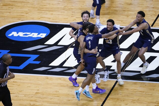 Oral Roberts players celebrate at the end of a college basketball game against Florida in the second round of the NCAA tournament at Indiana Farmers Coliseum, Sunday, March 21, 2021 in Indianapolis. Oral Roberts won 81-78. (AP Photo/AJ Mast)