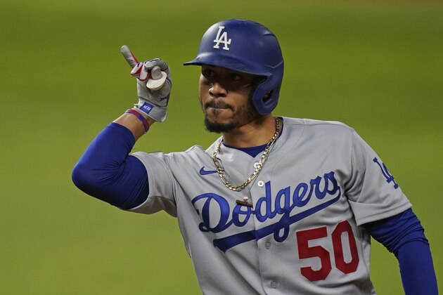 Los Angeles Dodgers' Mookie Betts celebrates his RBI single against the Tampa Bay Rays during the fourth inning in Game 3 of the baseball World Series Friday, Oct. 23, 2020, in Arlington, Texas. (AP Photo/Eric Gay)