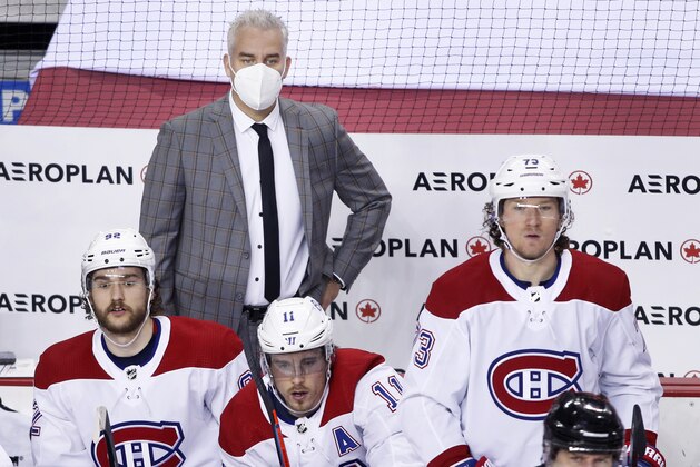 Montreal Canadiens head coach Dominique Ducharme, center, during an NHL hockey game, Thursday, March 11, 2021, in Calgary, Canada. (AP Photo/Larry MacDougal)