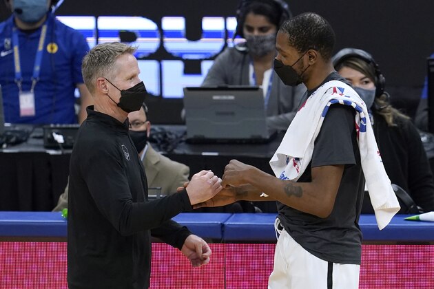 Golden State Warriors coach Steve Kerr, left, greets Brooklyn Nets forward Kevin Durant after the Nets defeated the Warriors in an NBA basketball game in San Francisco, Saturday, Feb. 13, 2021. (AP Photo/Jeff Chiu)