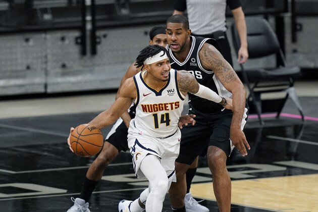 Denver Nuggets guard Gary Harris (14) drives around San Antonio Spurs center LaMarcus Aldridge (12) during the first half of an NBA basketball game in San Antonio, Friday, Jan. 29, 2021. (AP Photo/Eric Gay)