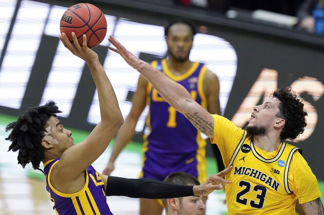 LSU forward Trendon Watford, left, shoots over Michigan forward Brandon Johns Jr. (23) during the second half of a second-round game in the NCAA men's college basketball tournament at Lucas Oil Stadium Monday, March 22, 2021, in Indianapolis. (AP Photo/Darron Cummings)