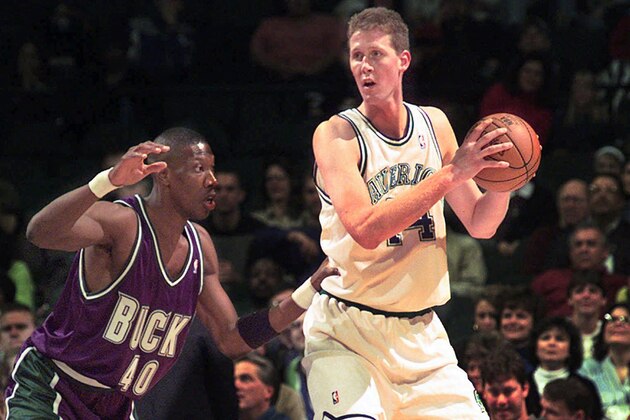 FILE- In this Nov. 22, 1997, file photo, Dallas Mavericks' Shawn Bradley (44) looks to pass as Milwaukee Bucks' Ervin Johnson (40) defends during the first quarter of an NBA basketball game at the Reunion Arena in Dallas. Former NBA player Shawn Bradley was paralyzed when he was struck from behind by a vehicle while riding a bike near his Utah home, saying in a statement nearly two months after the accident he intended to bring awareness to bicycle safety. (AP Photo/LM Otero, File)