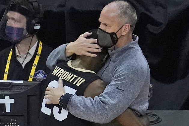 Colorado head coach Tad Boyle hugs McKinley Wright IV as he heads to the bench near the end of his teams 71-53 loss to Florida State during the second half of a second-round game in the NCAA college basketball tournament at Farmers Coliseum in Indianapolis, Monday, March 22, 2021. (AP Photo/Charles Rex Arbogast)