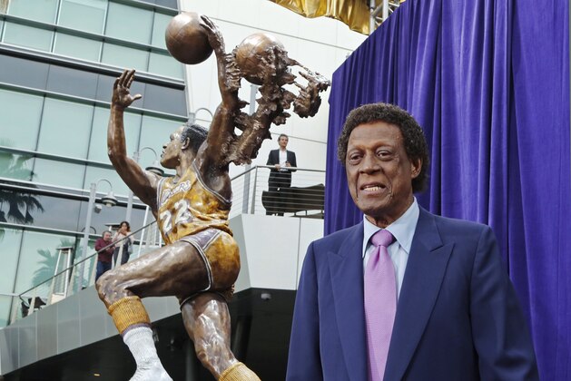 FILE - Elgin Baylor stands next to a statue, just unveiled, honoring the Minneapolis and Los Angeles Lakers great, outside Staples Center in Los Angeles, in this Friday, April 6, 2018, file photo. Elgin Baylor, the Lakers’ 11-time NBA All-Star, died Monday, March 22, 2021, of natural causes. He was 86. The Lakers announced that Baylor died in Los Angeles with his wife, Elaine, and daughter Krystal by his side. (AP Photo/Reed Saxon, File) FILE - Elgin Baylor stands next to a statue, just unveiled, honoring the Minneapolis and Los Angeles Lakers great, outside Staples Center in Los Angeles, in this Friday, April 6, 2018, file photo. Elgin Baylor, the Lakers’ 11-time NBA All-Star, died Monday, March 22, 2021, of natural causes. He was 86. The Lakers announced that Baylor died in Los Angeles with his wife, Elaine, and daughter Krystal by his side. (AP Photo/Reed Saxon, File)