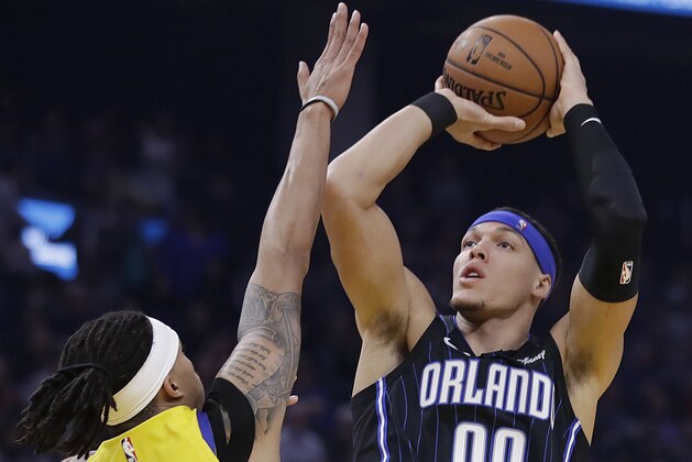 Orlando Magic's Aaron Gordon, right, shoots against Golden State Warriors' Damion Lee, left, bin the first half of an NBA basketball game Saturday, Jan. 18, 2020, in San Francisco. (AP Photo/Ben Margot)