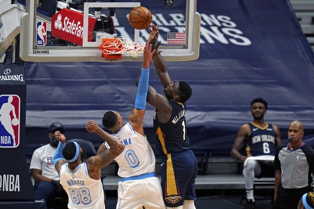 New Orleans Pelicans forward Zion Williamson (1) goes to the basket against Los Angeles Lakers forward Kyle Kuzma (0) during the first half of an NBA basketball game in New Orleans, Tuesday, March 23, 2021. (AP Photo/Gerald Herbert)