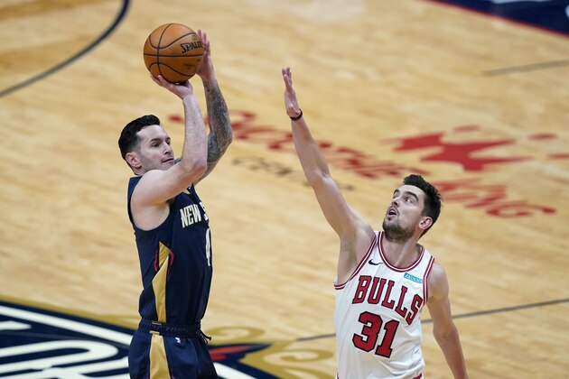 New Orleans Pelicans guard JJ Redick shoots next to Chicago Bulls guard Tomas Satoransky (31) during the first half of an NBA basketball game in New Orleans, Wednesday, March 3, 2021. (AP Photo/Gerald Herbert)