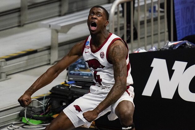 Arkansas guard Davonte Davis (4) reacts after a dunk against Texas Tech in the second half of a second-round game in the NCAA men's college basketball tournament at Hinkle Fieldhouse in Indianapolis, Sunday, March 21, 2021. (AP Photo/Michael Conroy)