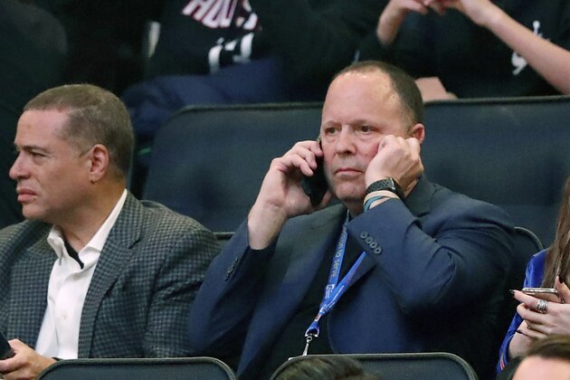 FILE - In this March 2, 2020, file photo, New York Knicks president Leon Rose, center, takes a phone call during the first quarter of an NBA basketball game against the Houston Rockets in New York. Rose didn't have much time to evaluate the Knicks after becoming team president in March. But with their season officially over, he can begin making changes after another losing season. (AP Photo/Kathy Willens, File)